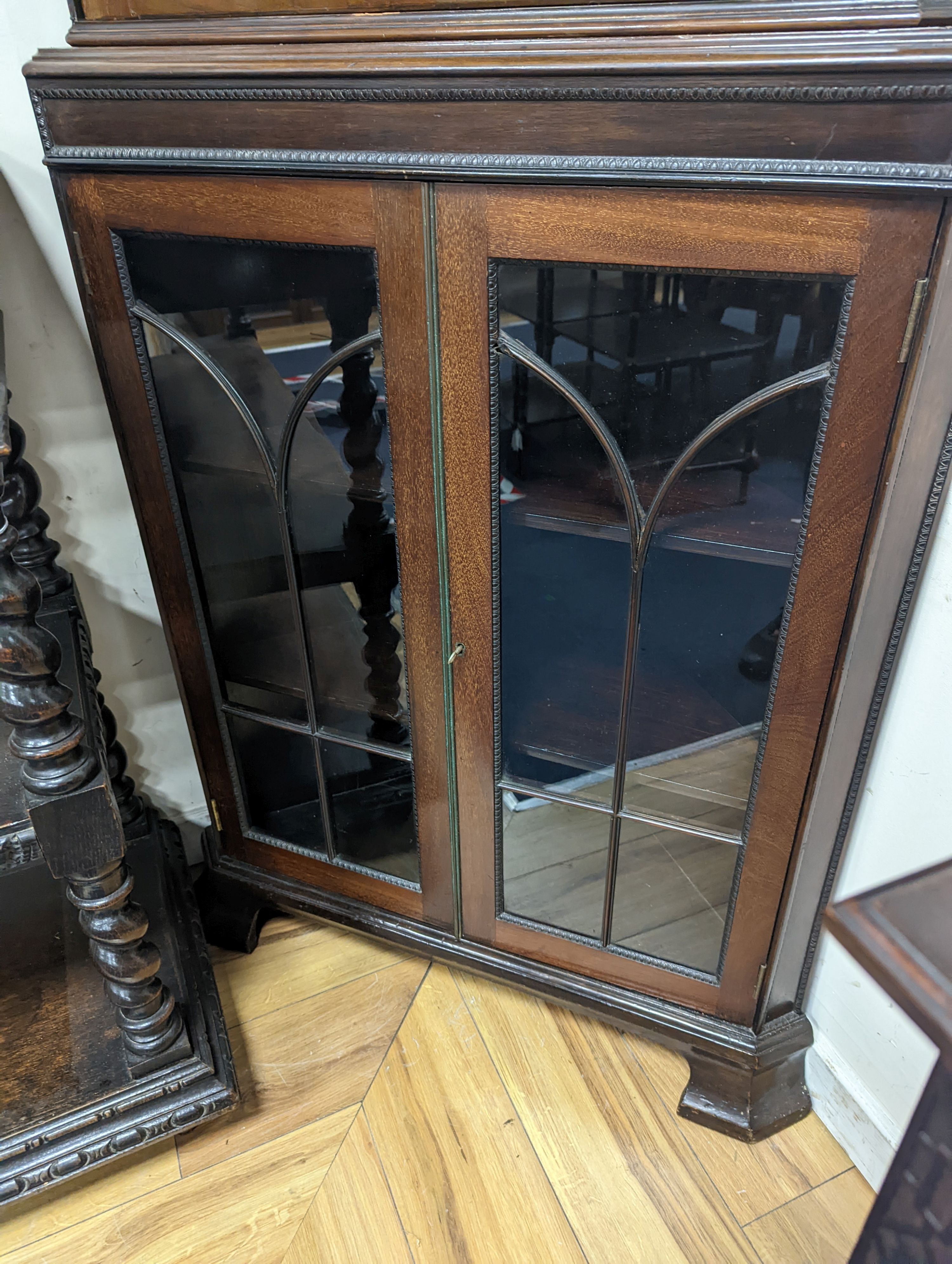 An Edwardian mahogany glazed standing corner cabinet, fitted four shelves, width 80cm, depth 42cm, height 196cm